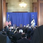 Secretary Wilbur Ross speaking at podium before audience