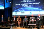 Kevin O'Connell (holding mic) and six other panelists on stage