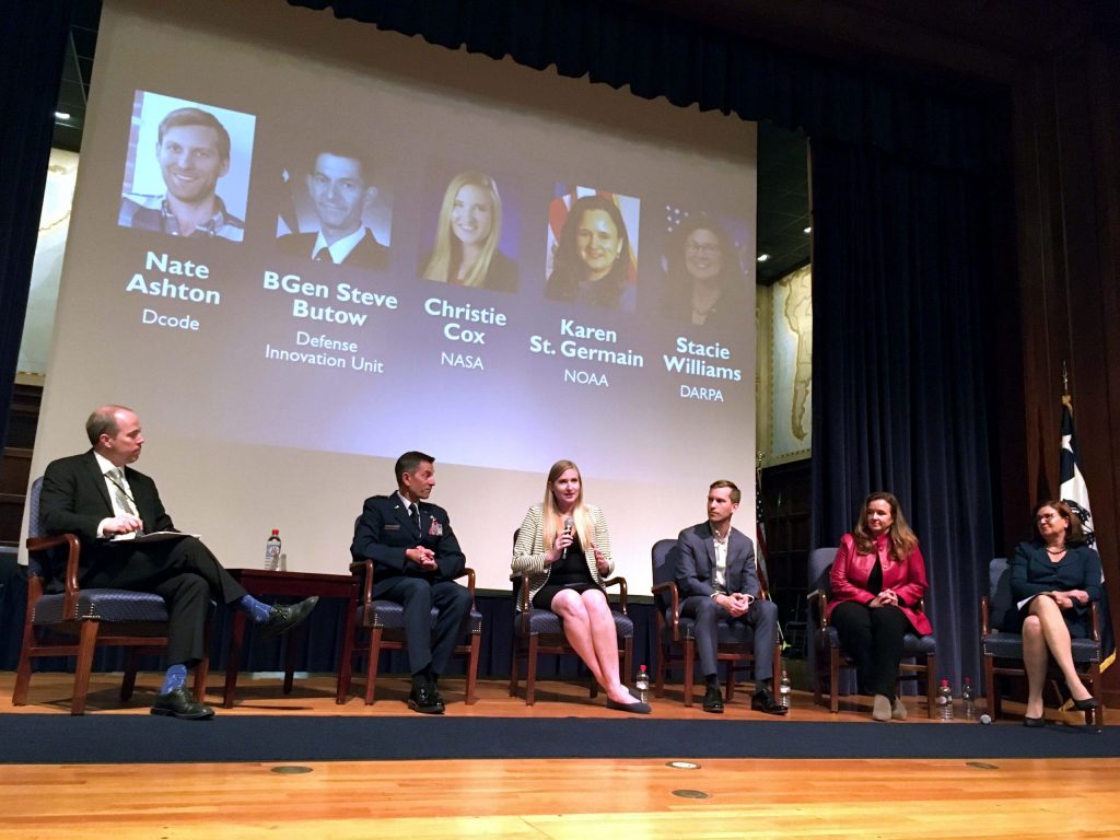 Michael Beavin and five panelists seated on stage