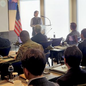 Jason Kim speaking at podium before audience