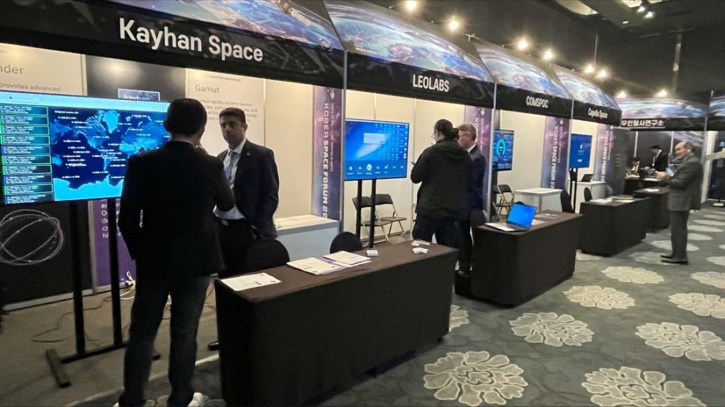 Exhibit hall with booths for Kayhan Space, LeoLabs, COMSPOC, and Capella Space