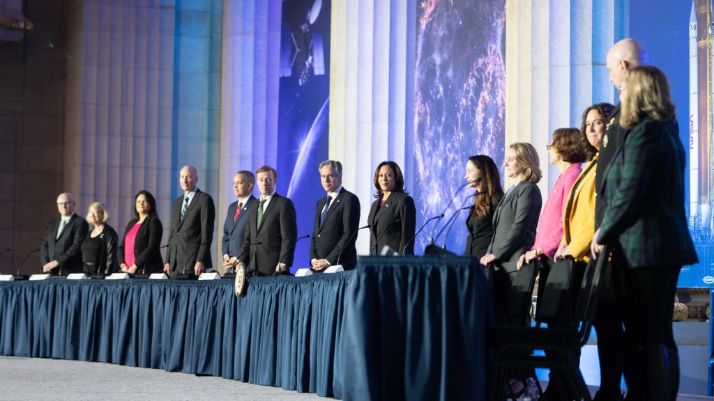 National Space Council principals standing at the dais with Vice President Harris smiling at center