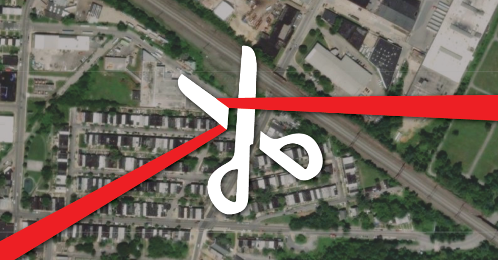 Scissors cutting a red tape over a satellite image of a city