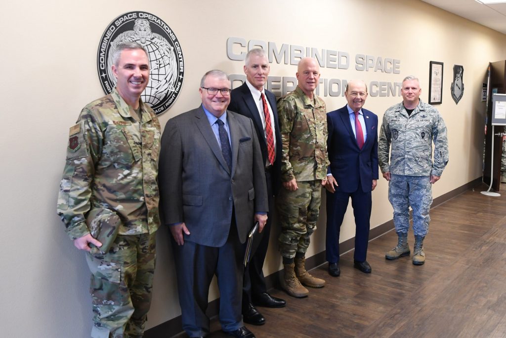 Secretary of Commerce Wilbur Ross, Office of Space Commerce Director Kevin O'Connell, Earl Comstock, and AF leadership in front of the CSPOC sign